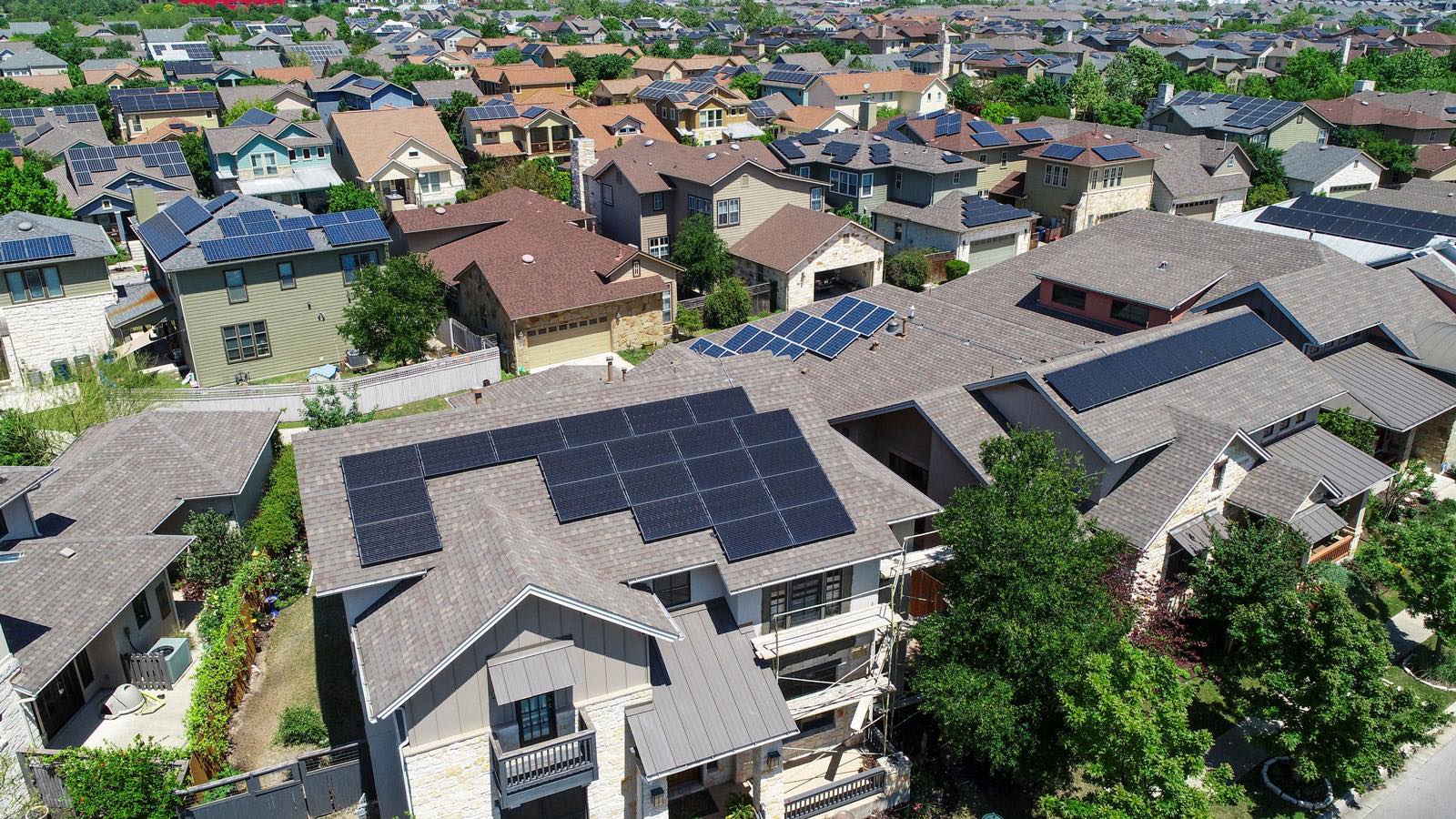 A view of houses with solar panels on the roof.